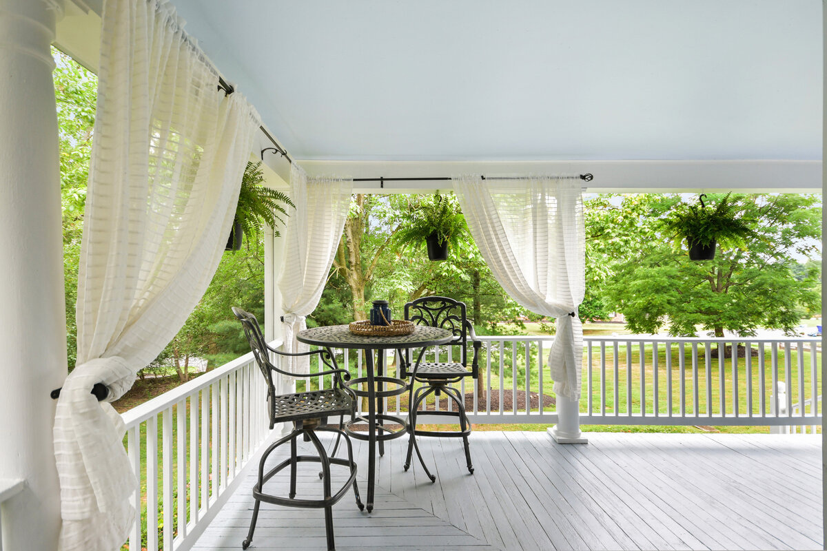 Patio with bar table and white curtains