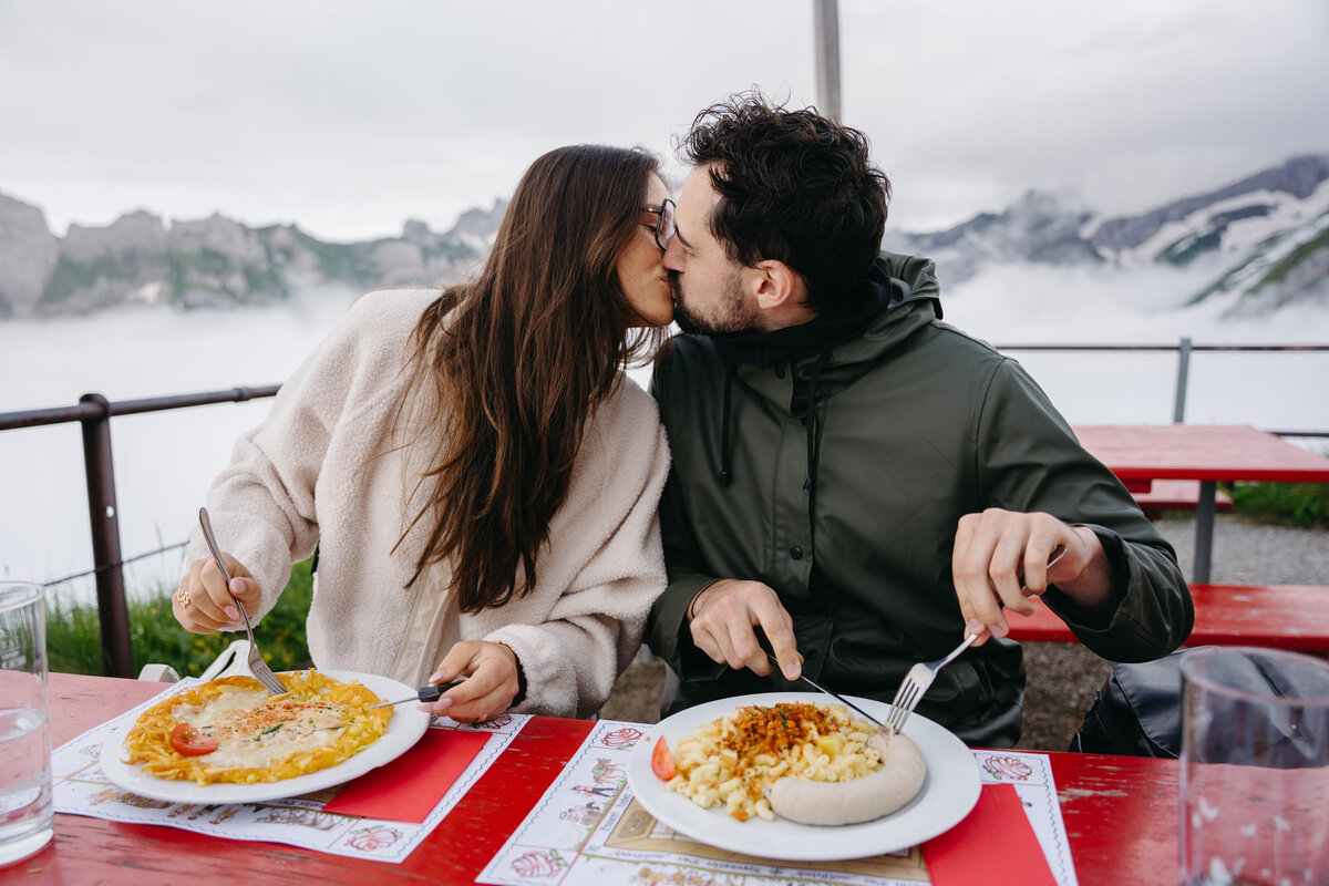 Couple enjoying breakfast at a hut in Switzerland