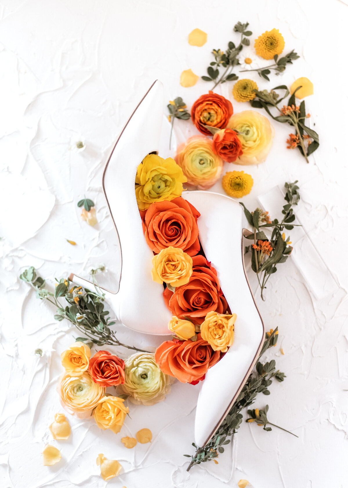 Brides wedding shoes detail shot with florals