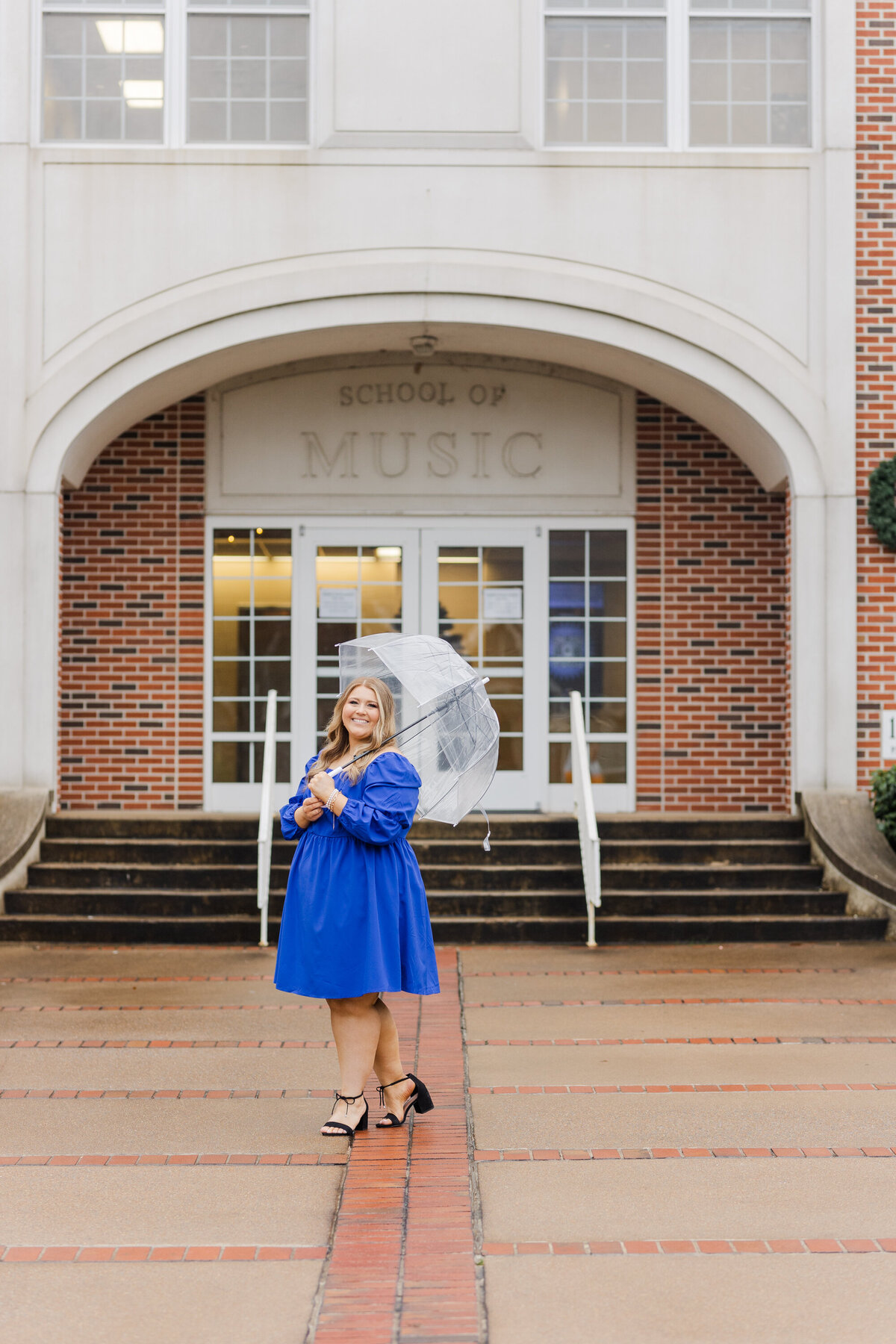 college senior holding an umbrella for photos