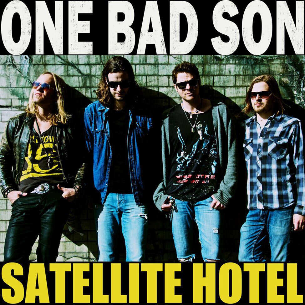 Single Cover Title Satellite Hotel four members of One Bad Son standing against weathered wood wall