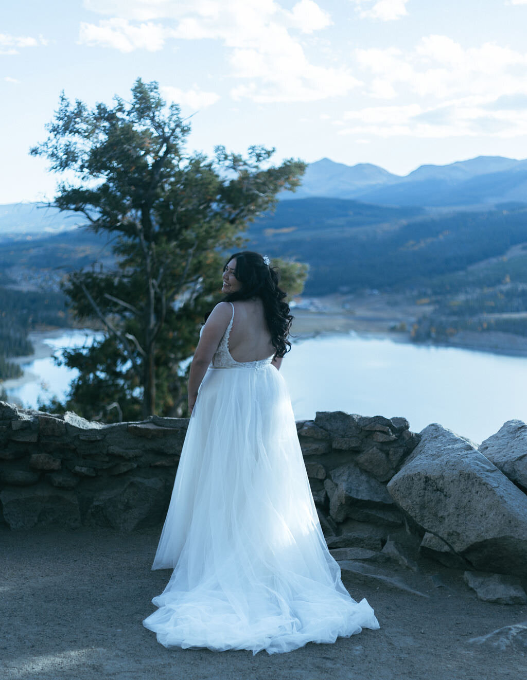 A person in a wedding dress looking over her shoulder.