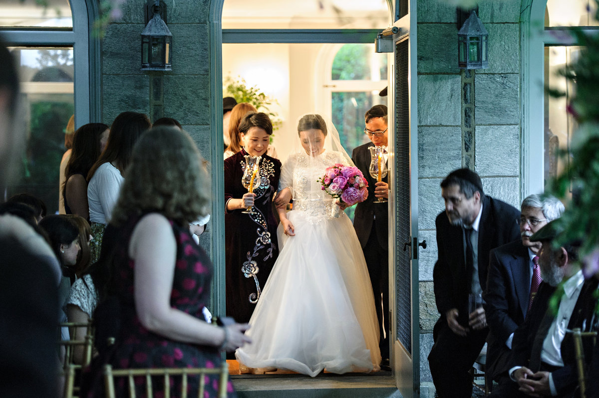 A bride is walked down the isle by her parents at this intimate ceremony in Merion Station.