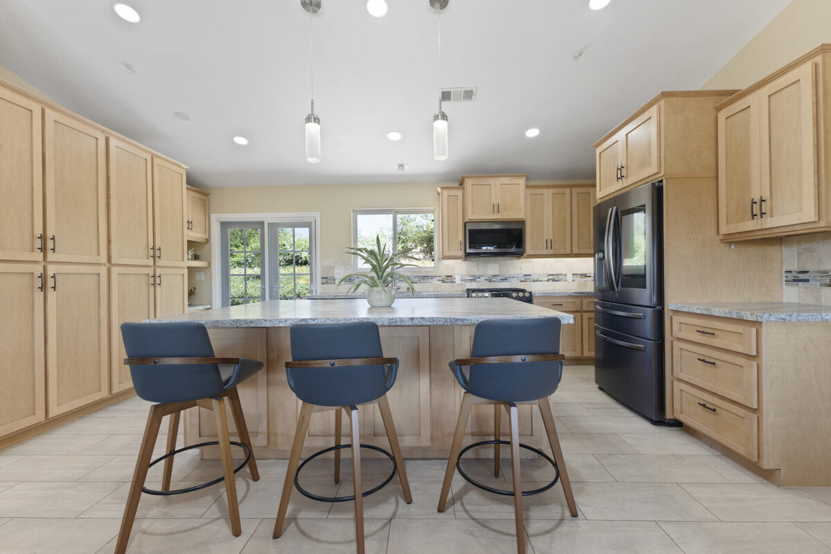 Updated kitchen with blue stools. Traditional living and dining room. Real Estate home in Ramona