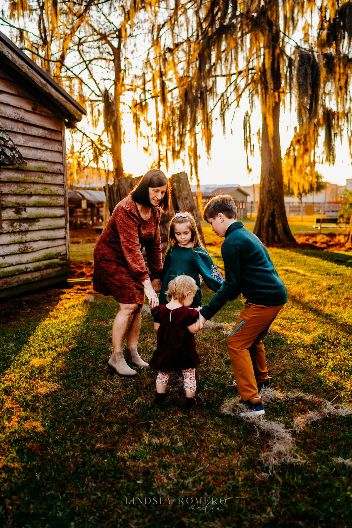Grandmother and grandchildren playing at sunset in Patterson, la