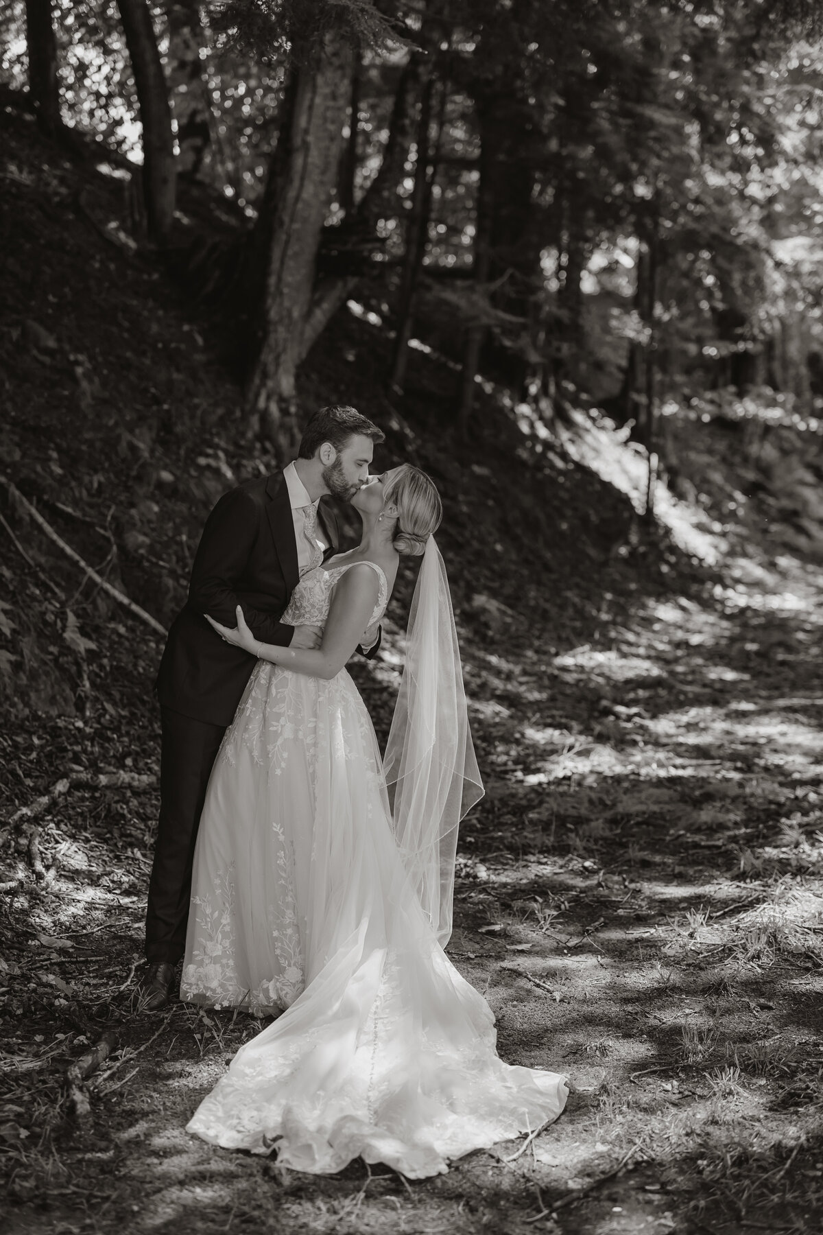 A fine art New England wedding photographer documents a touching first look as the bride and groom share a quiet moment surrounded by the natural beauty of the New England forest—an intimate and timeless scene perfect for nature-loving couples.