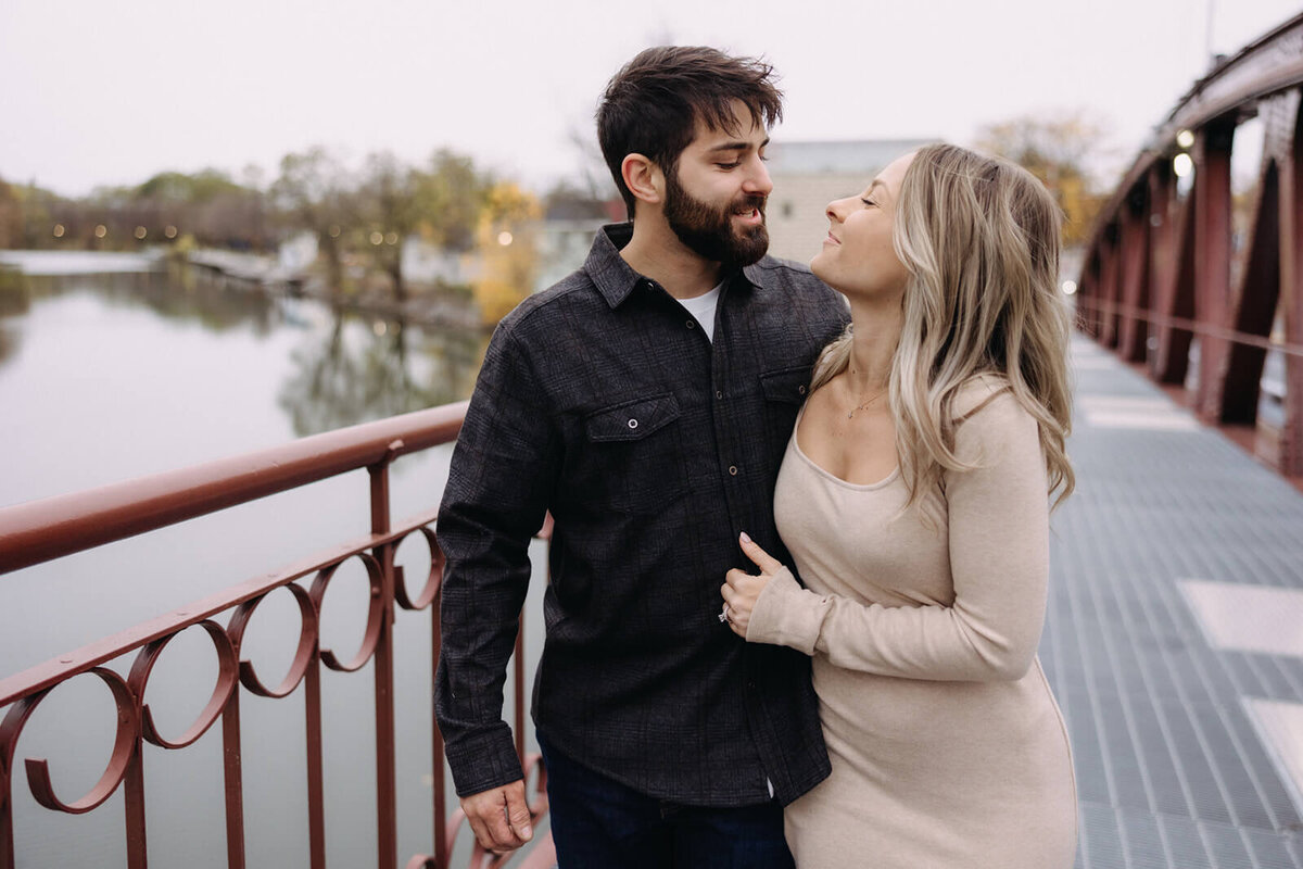 Couple walking along bridge at at Finger Lakes maternity session
