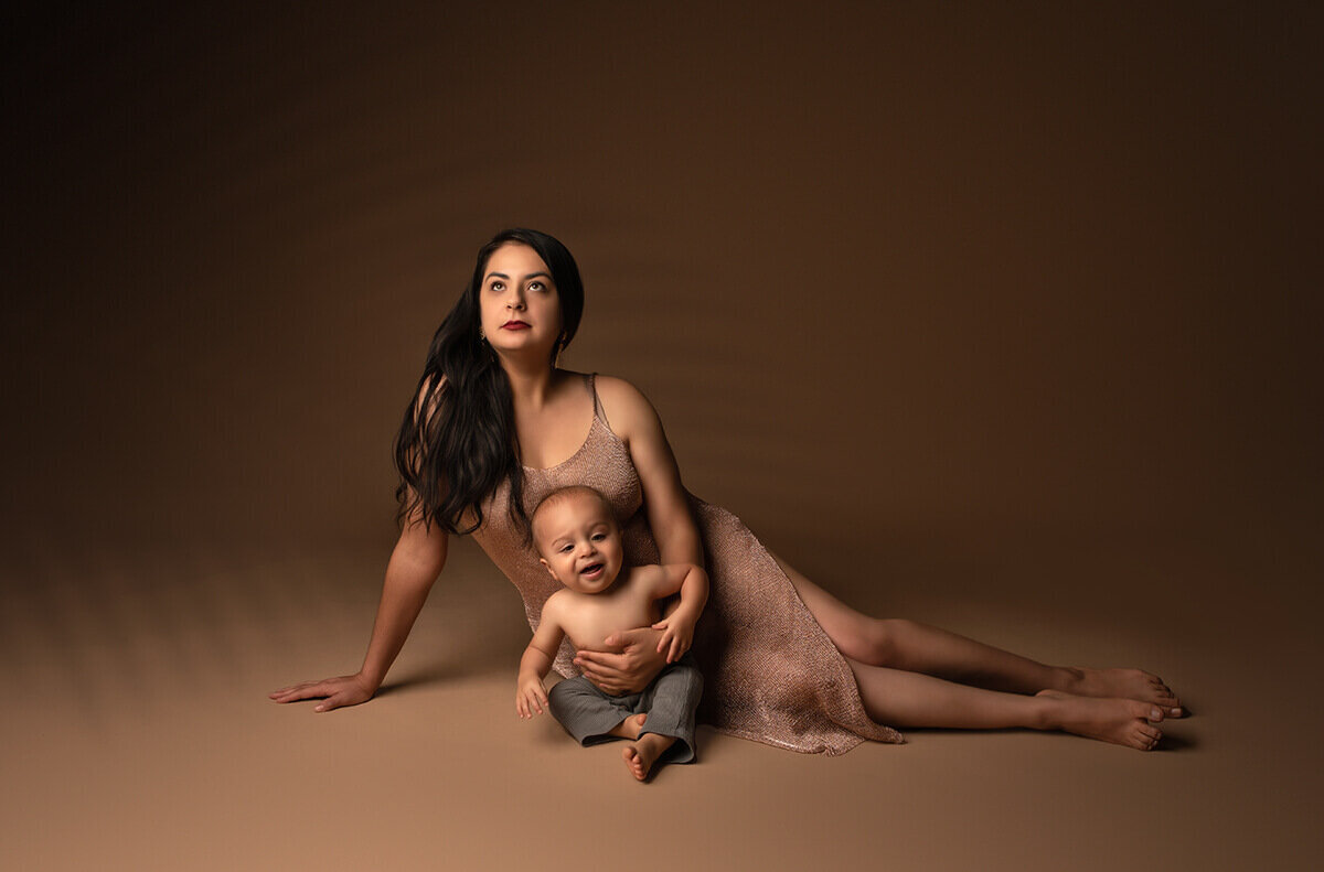 a mom sitting down posed with baby boy