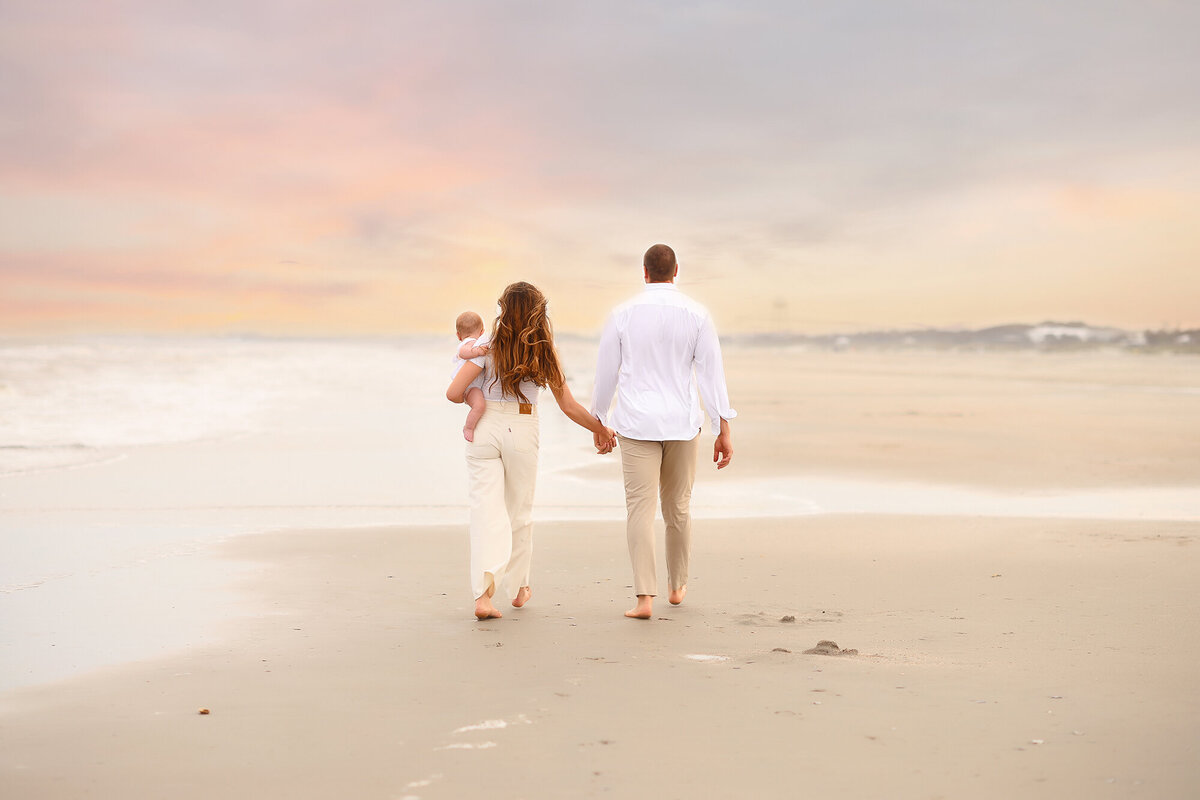 Family walks along together  during Family Pictures on Isle of Palms. 