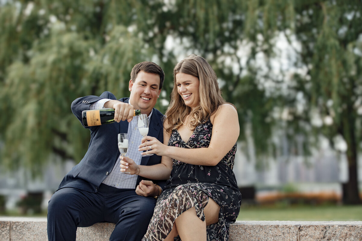 Couple doing champagne toast during engagement photos on Long Island New York