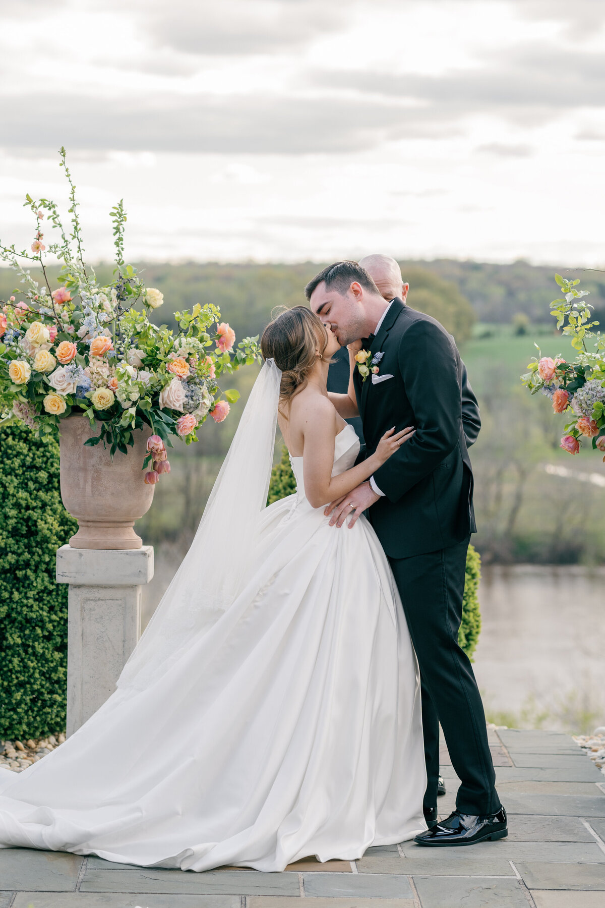 Estate at River Run Wedding in Maidens, VA | Wedding Photographer in Richmond | bride and groom sharing first kiss during their wedding ceremony on the Bluestone Terrace at the Estate at River Run