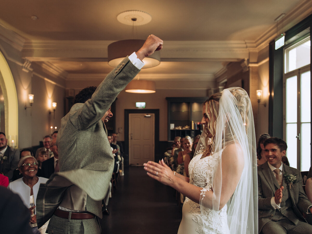 Groom celebrating after getting married at The Bell Hotel in Sandwich Kent