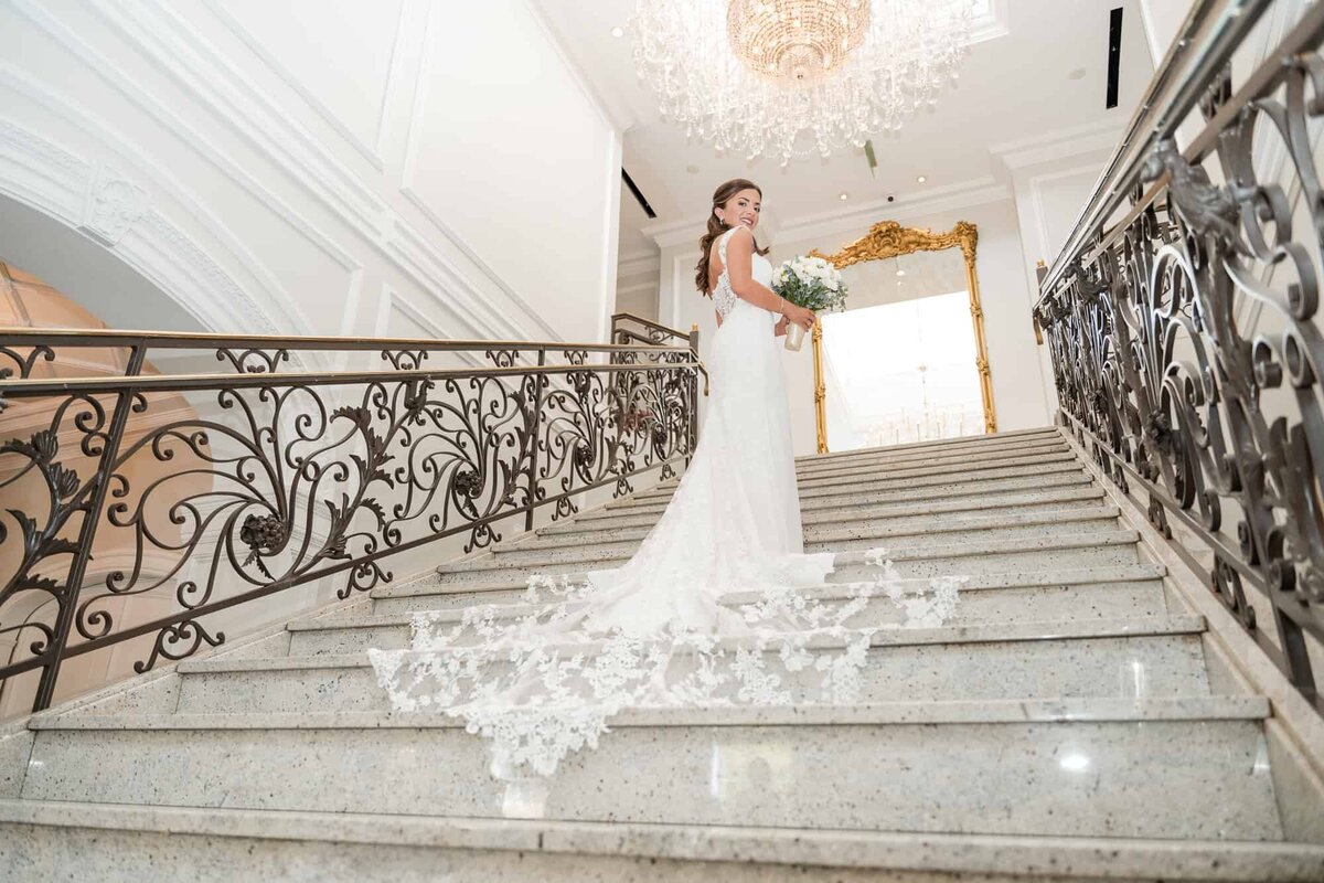 Bride posing in her wedding dress on the stairs at a Palm Beach Wedding venue in South Florida Captured by Fort Myers wedding Photographer