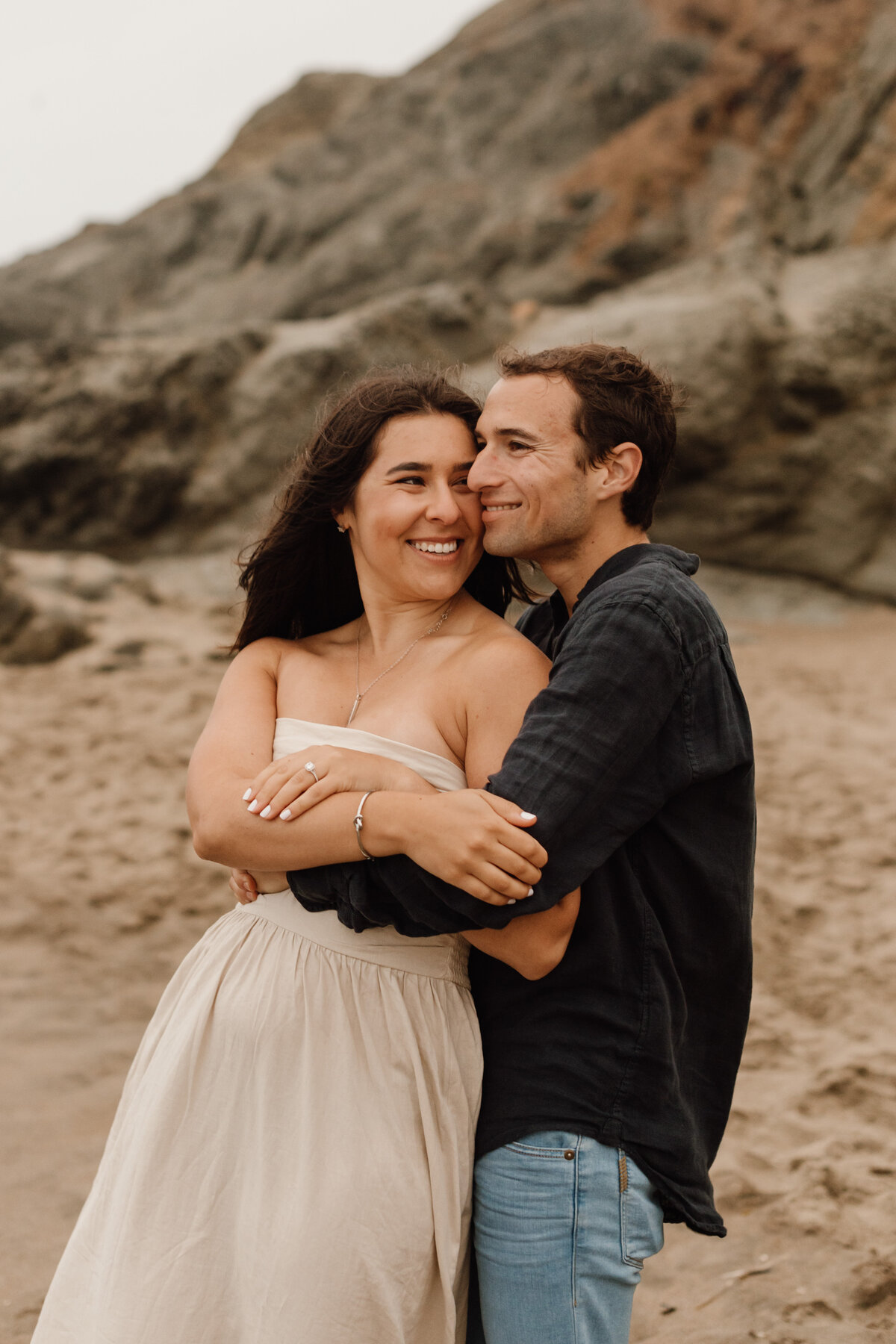 couple hugs on beach in san francisco