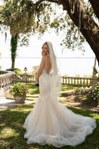 Stunning bridal portrait by St Augustine wedding photographer showing bride in elegant mermaid gown under oak trees at historic Florida venue