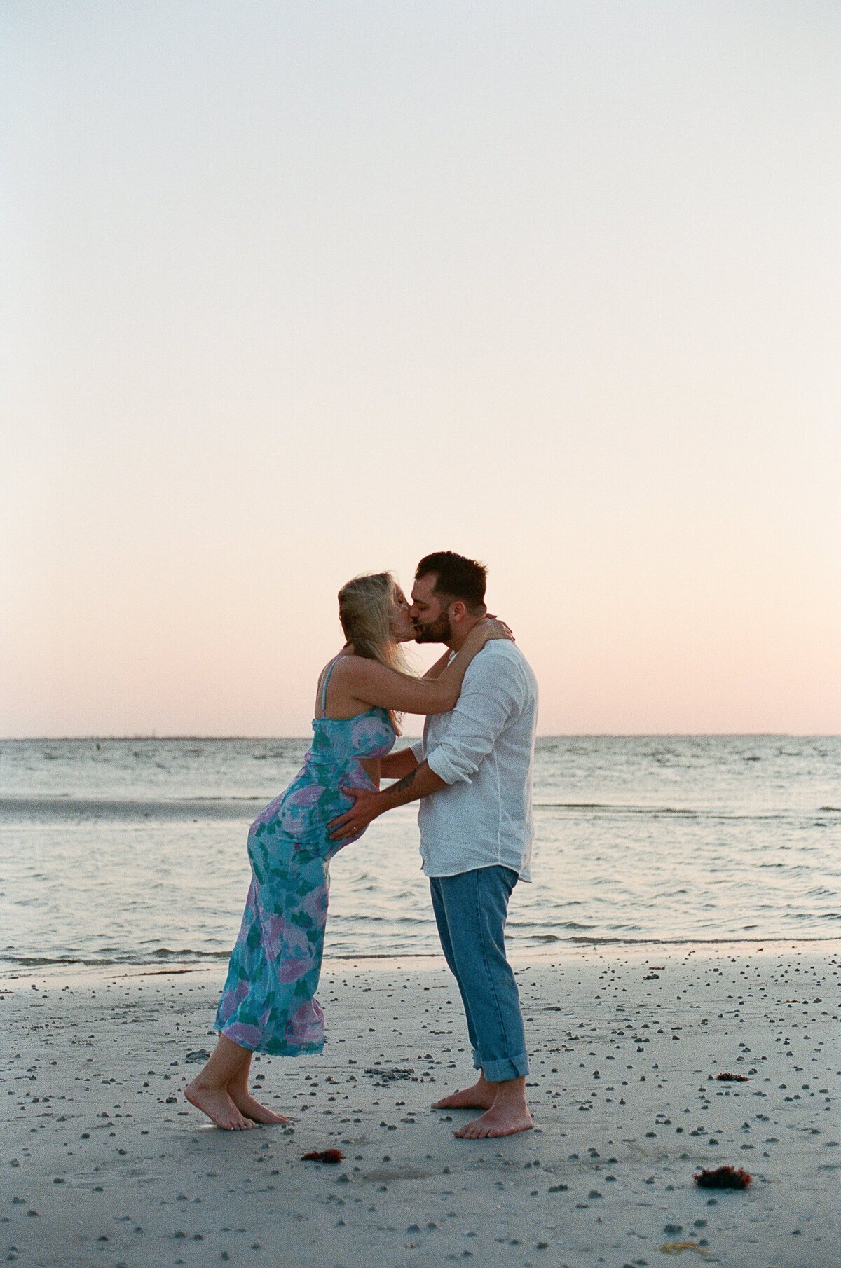 Couple on beach taken by film wedding photographers