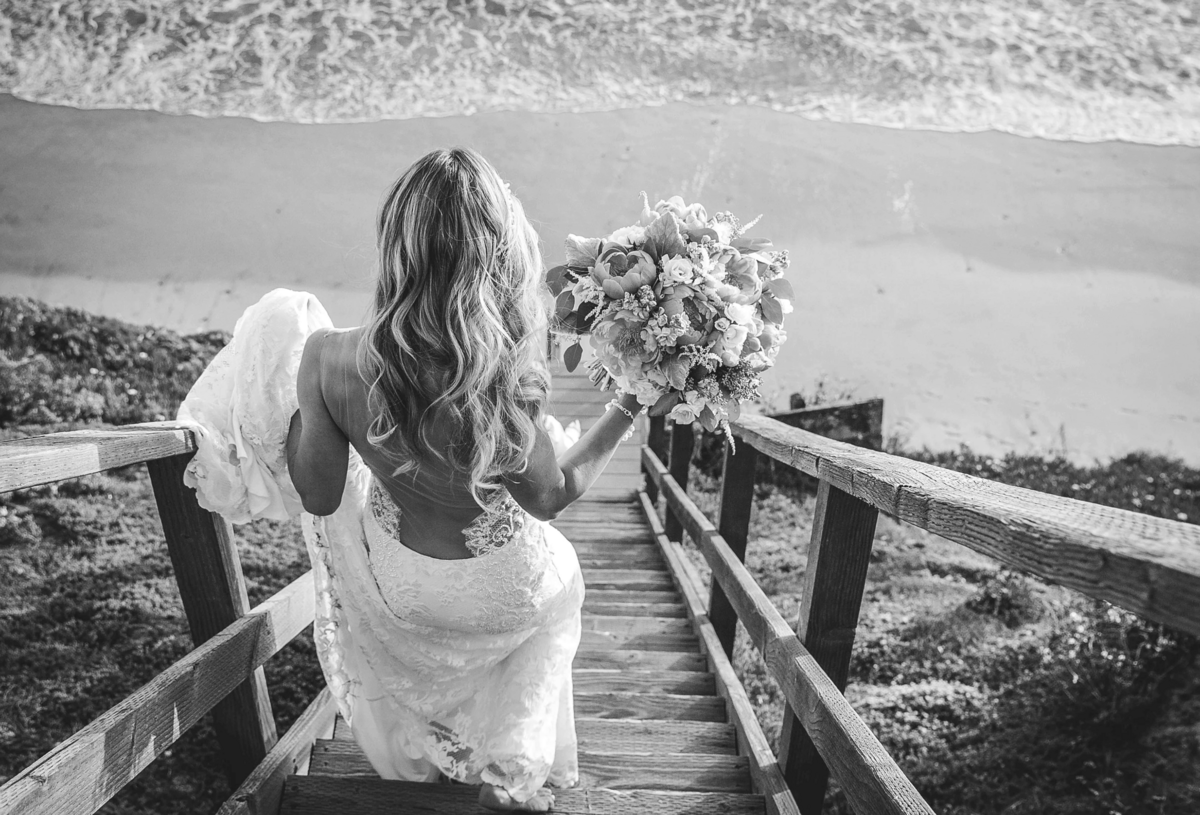bride-walking-down-beach-stairs-with-bouquet-san-diego-wedding-photography