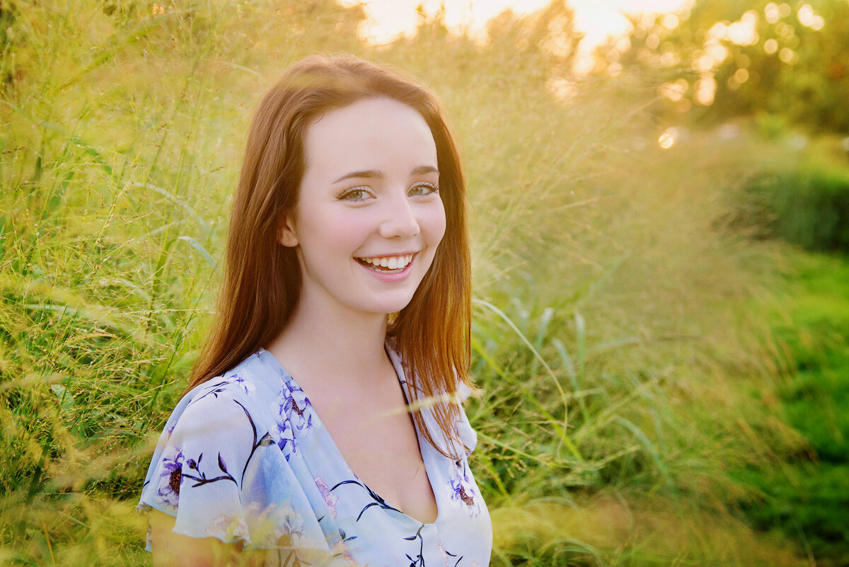 st-louis-senior-photographer-girl-standing-and-smiling-in-tall-grass