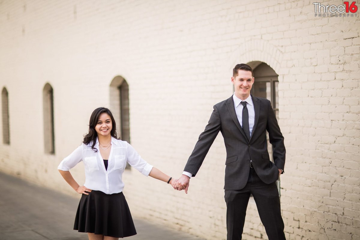 Engaged couple hold hands during an Old Pasadena photo session