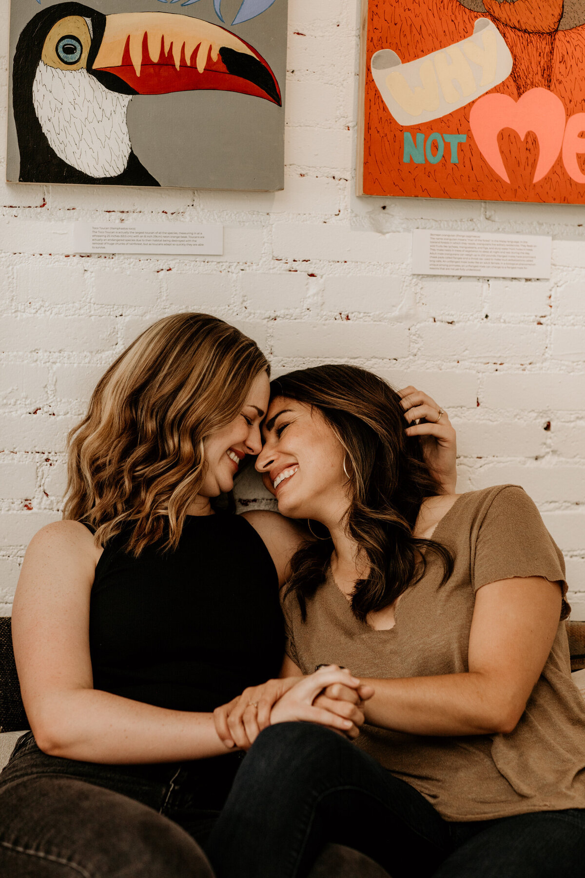 same sex couple sitting together on a couch where they had their first date