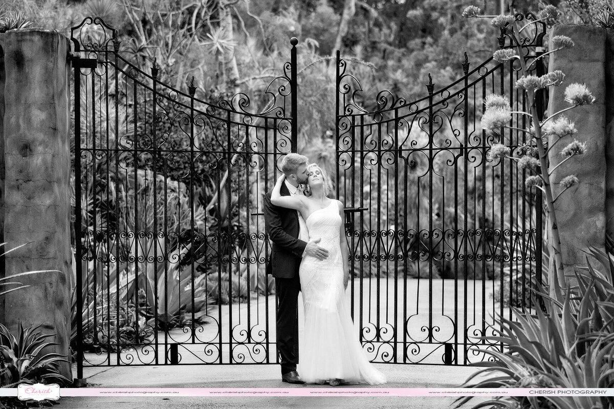 Stunning bride and groom portrait at the entrance of Villa Botanica, radiating romance.