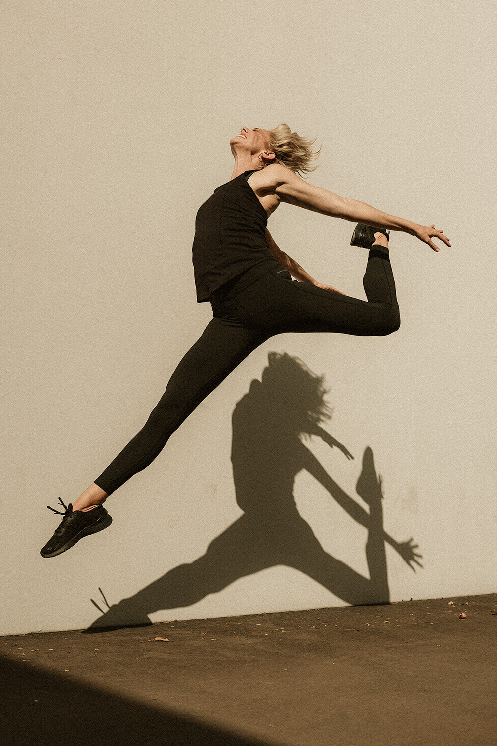 Bold, energetic movement captured mid-jump in golden light by Sunshine Coast branding photographer — perfect for active, expressive brands.