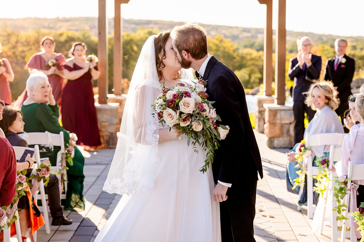 Bride and groom kissing in aisle after ceremony at Pembroke Pines Country Club wedding