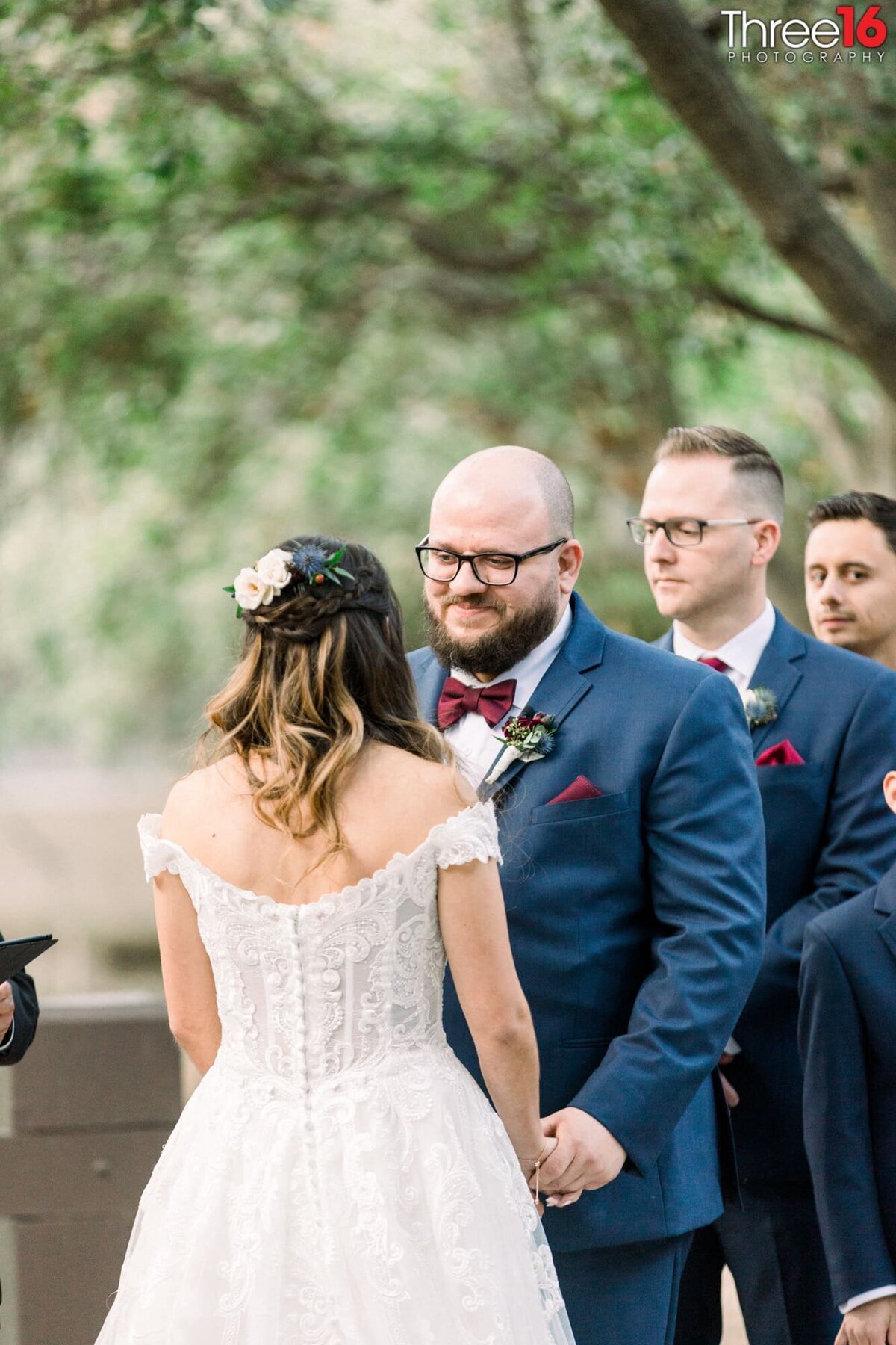 Groom smiles at his Bride as they take their vows