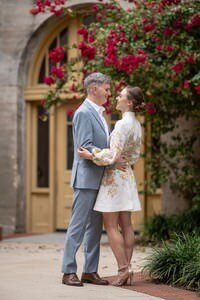 Romantic couple embracing in historic St Augustine courtyard with bougainvillea blooms, captured by professional intimate wedding photographers