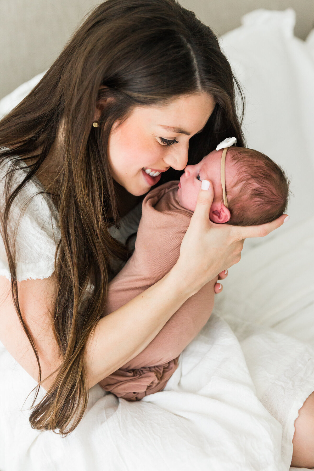 mom holding newborn baby in lifestyle Phoenix photography session