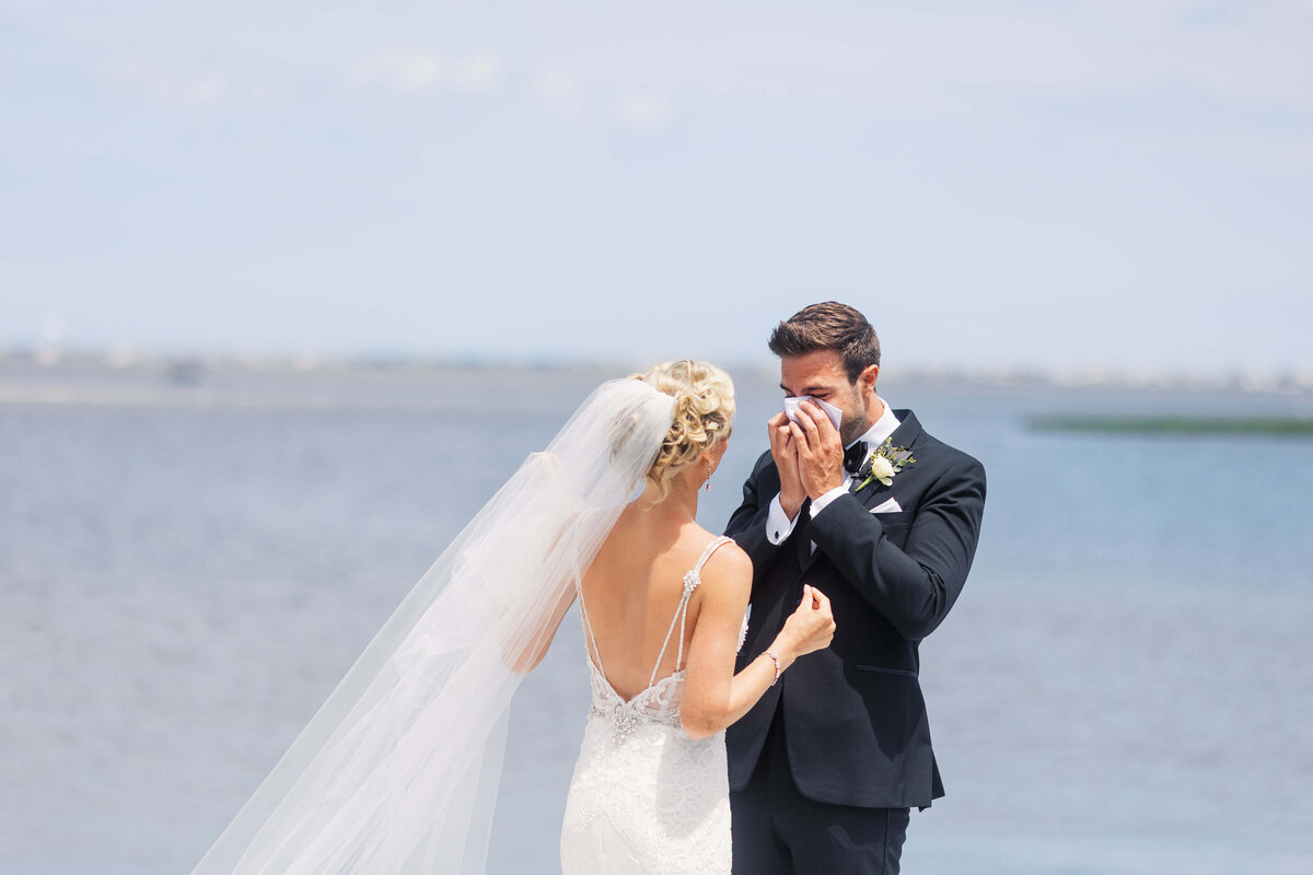 Groom cries as he sees his beautiful bride for the first time on their wedding day.