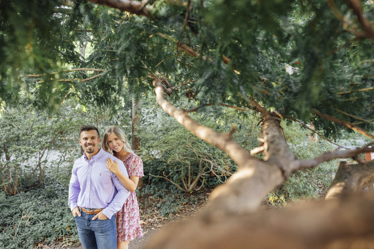 Couple under tree during engagement photo at Sayen House and Gardens in Hamilton Township New Jersey