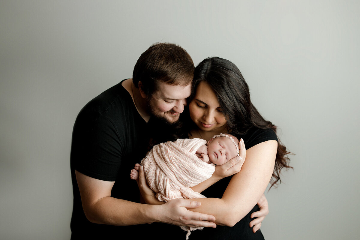 newborn and parents in whitefish photography studio