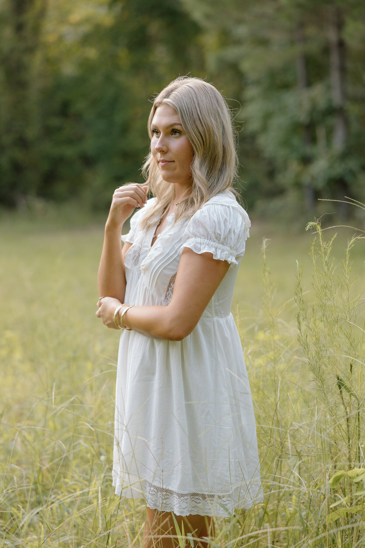 Senior photos in a field of tall grass