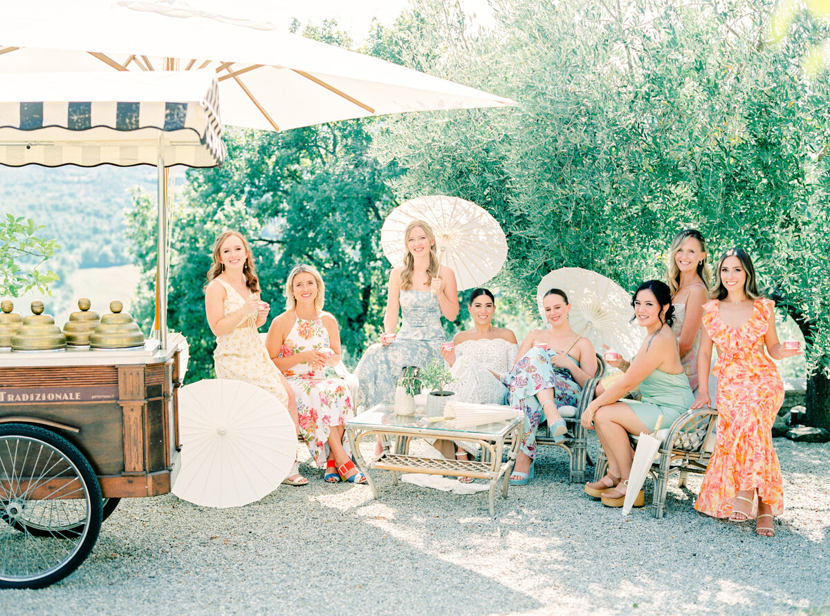 Film photograph of Bride and bridesmaids eating gelato by a gelato truck photographed by Italy wedding photographer at Villa Montanare Tuscany wedding