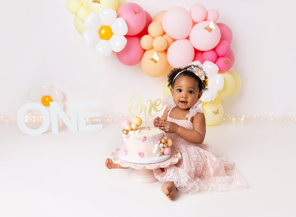 Cake smash photoshoot done for baby girl daisy theme pink yellow in Brooklyn studio by Rochel Konik Photography