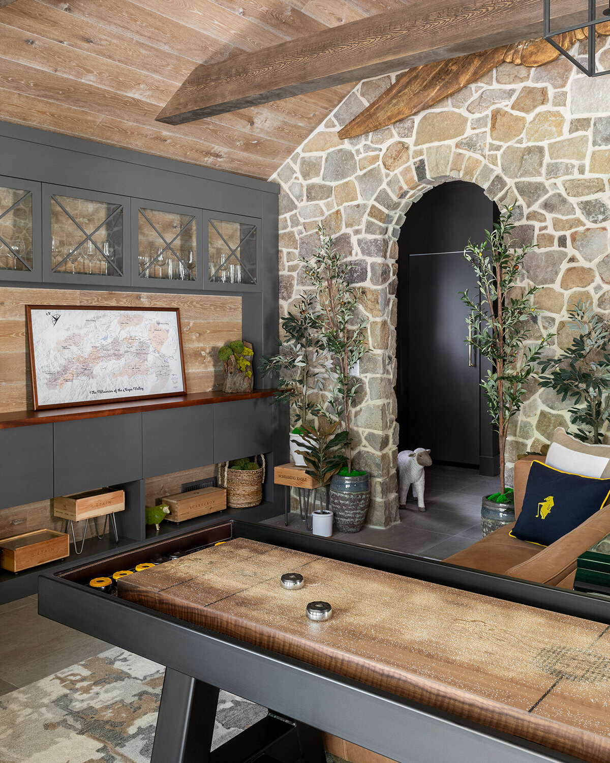 light wooden lounge area with black arch door