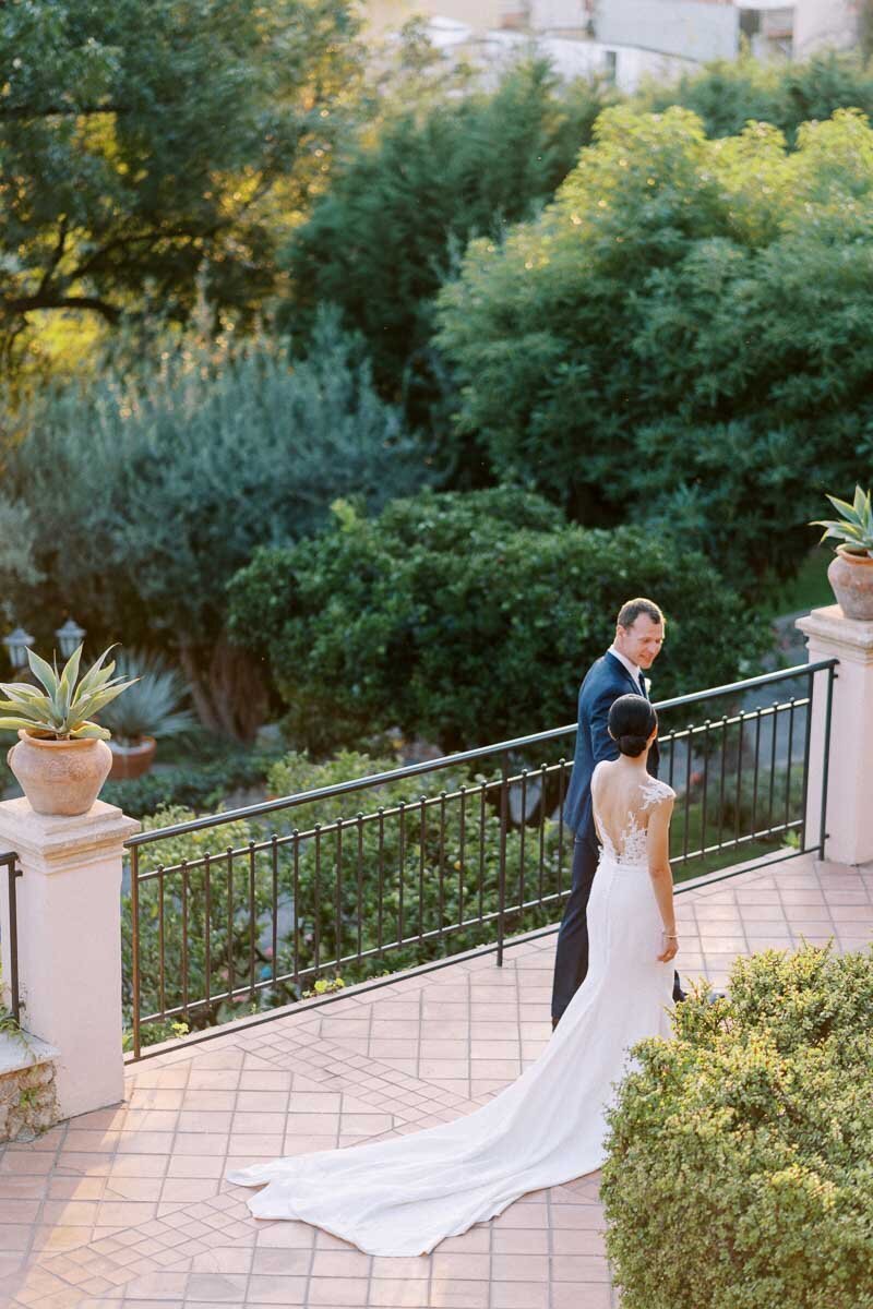 Bride and groom walking together at sunset on a beautiful villa terrace, captured in soft evening light by an Ontario wedding photographer
