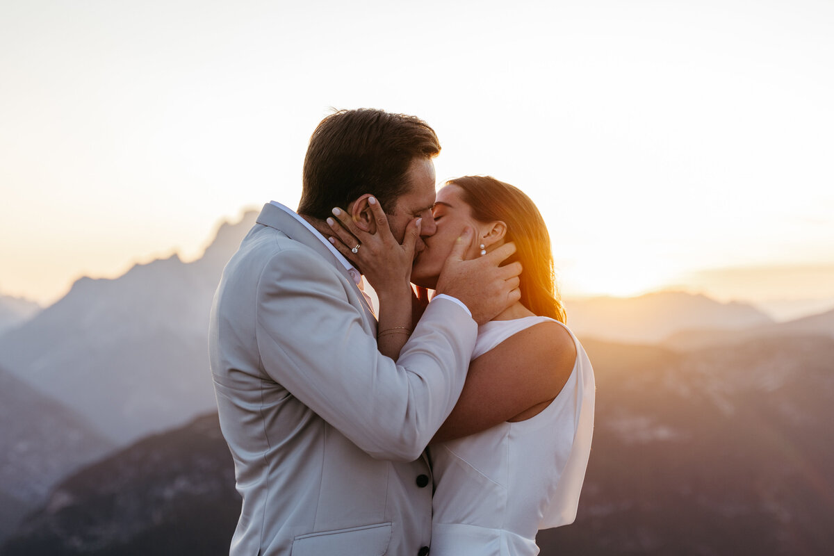 kissing couple mountain top elopement Tre Cime Dolomites