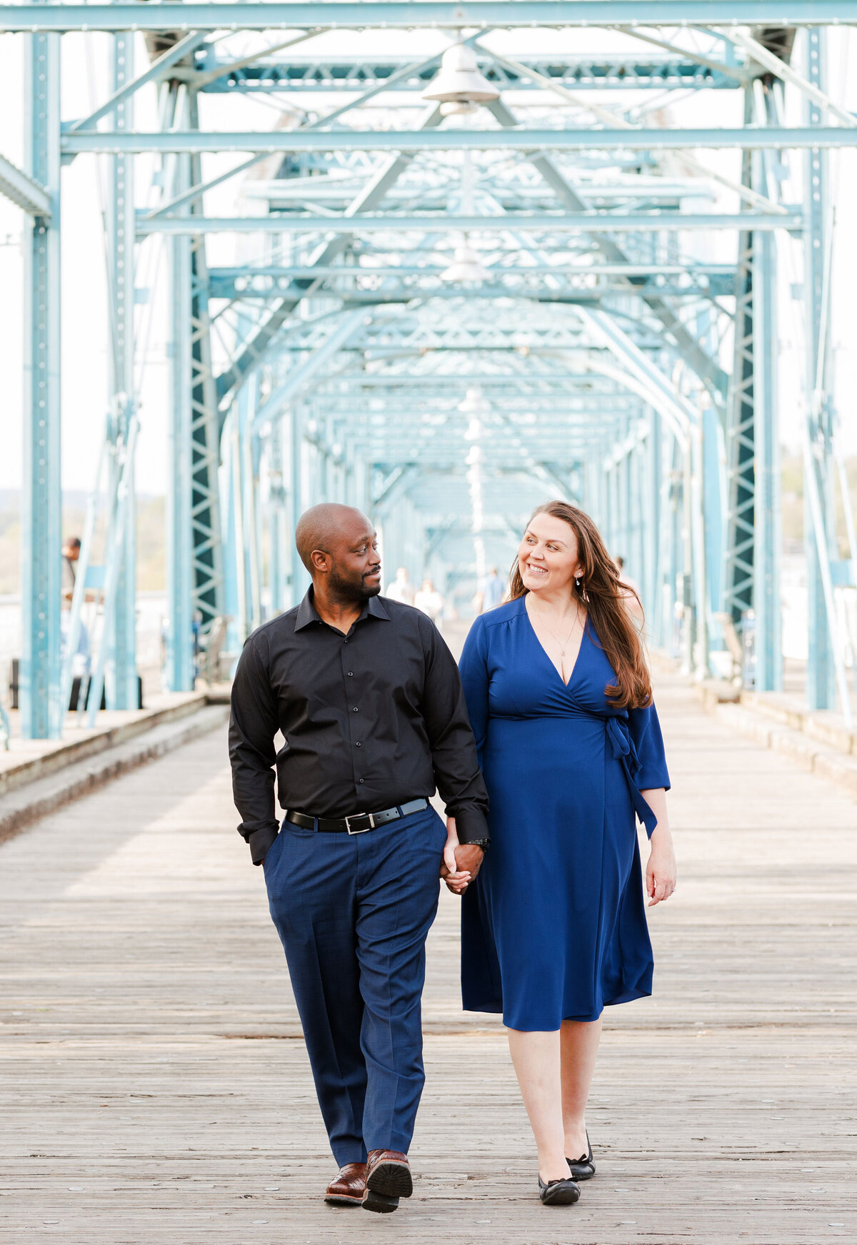 engaged couple walking on the Walnut Street Bridge