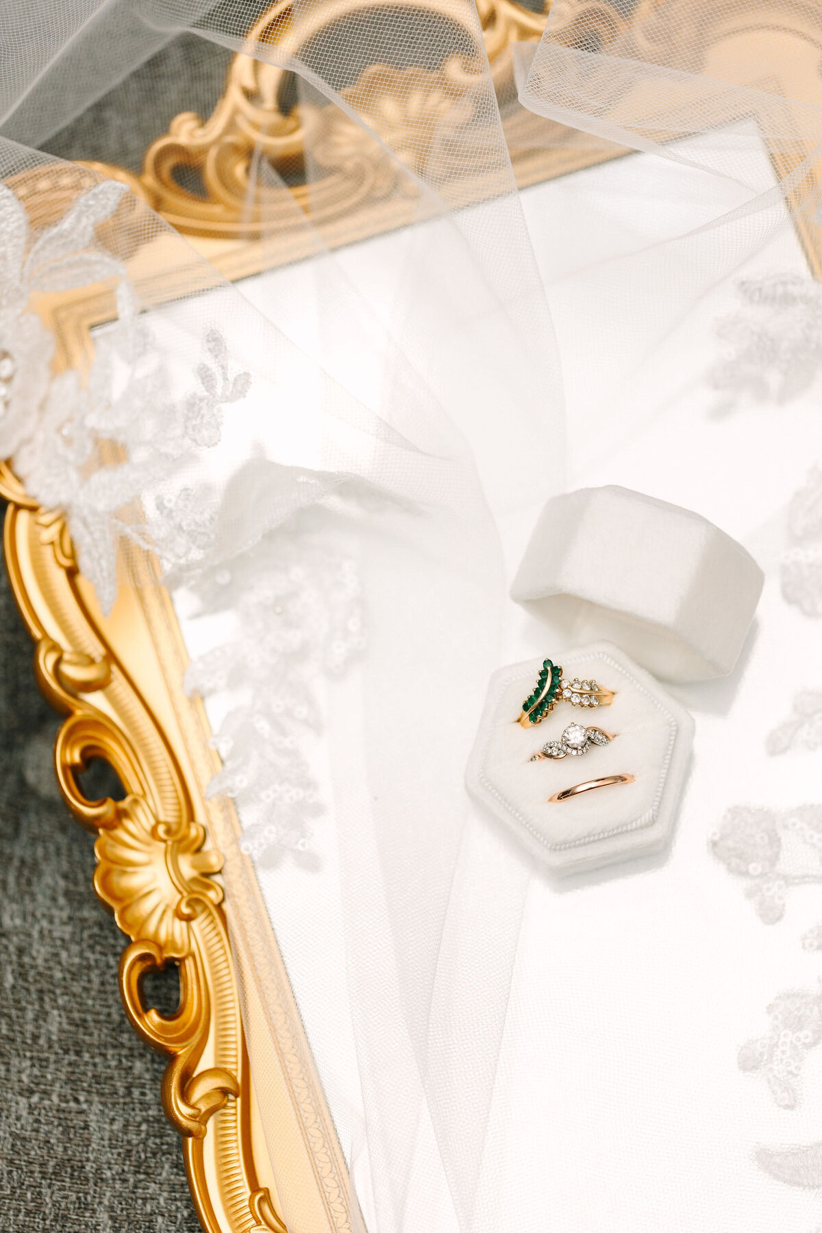 Wedding photography flatlay details with rings and mirror