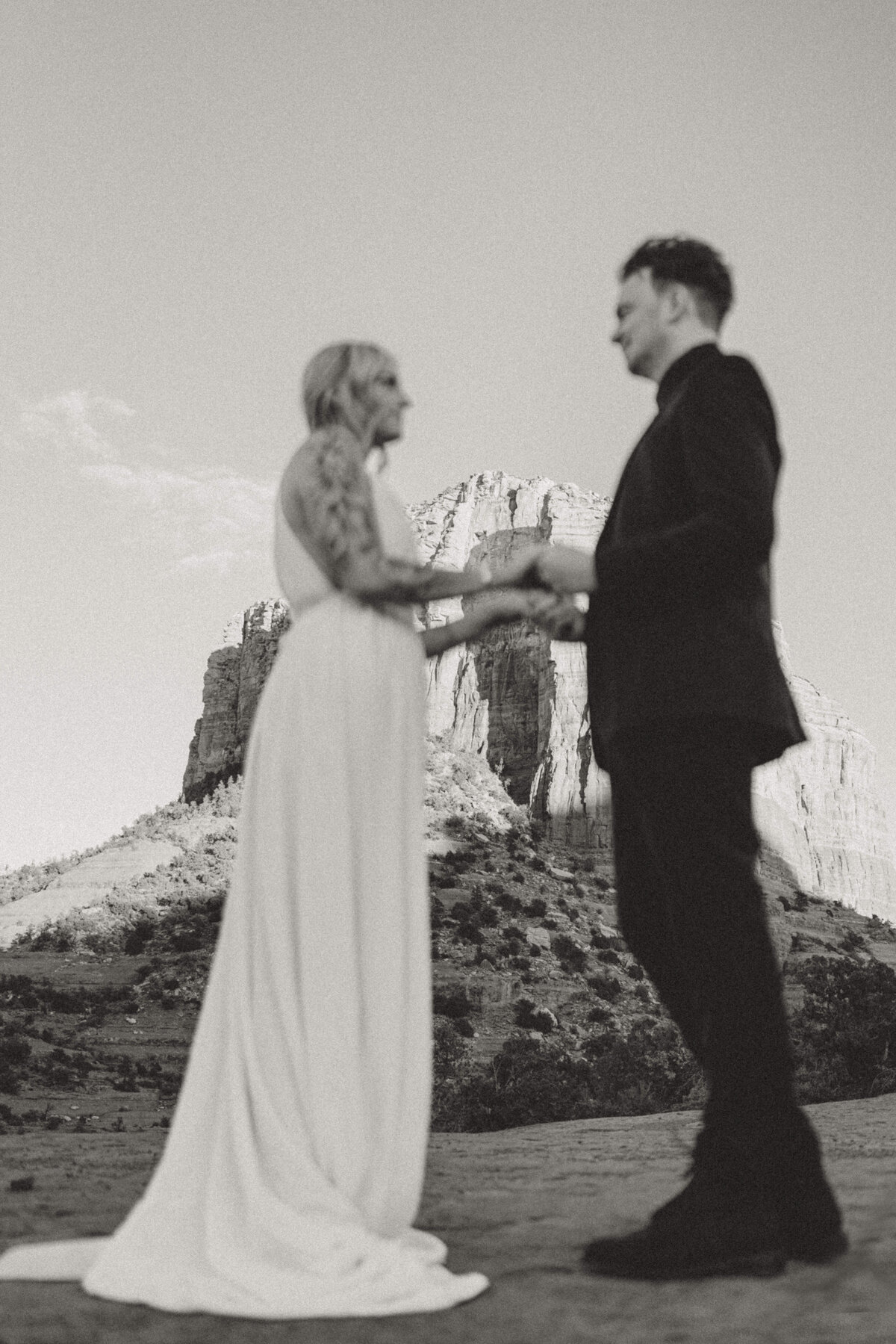 elopement-couple-holding-hands-courthouse-rock-sedona