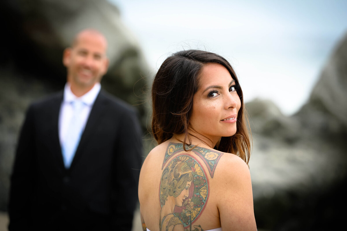 Weddings and Family Portraits in Orange County bride looking over shoulder