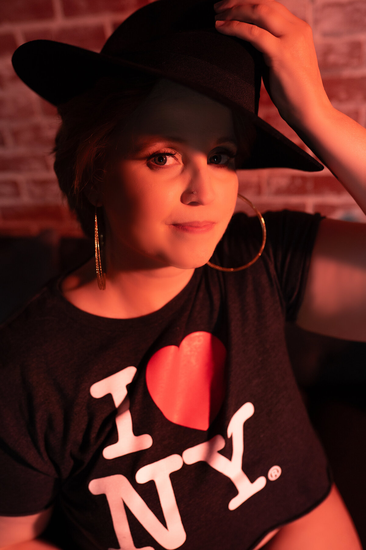 portrait of woman in I heart NY T shirt and fedora