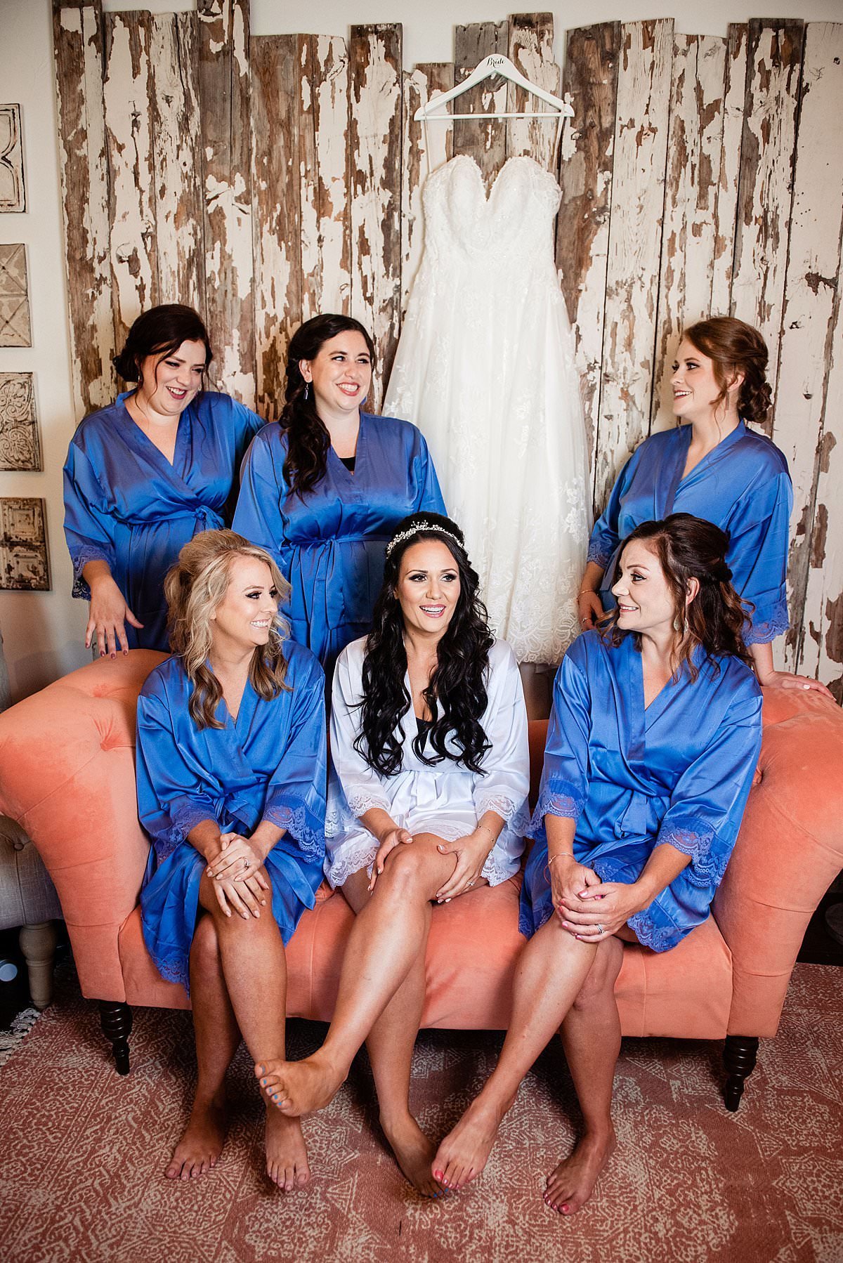 Bridesmaids sitting with the bride inside of the Headwaters Ranch bridal suite