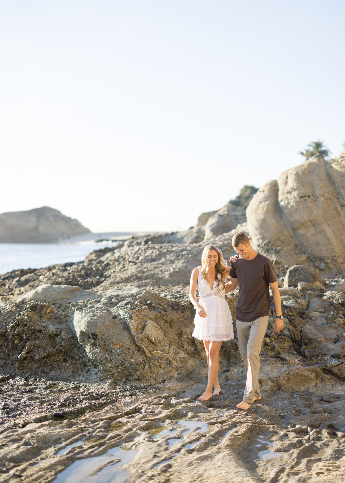 sweet engagement photo walking on the beach
