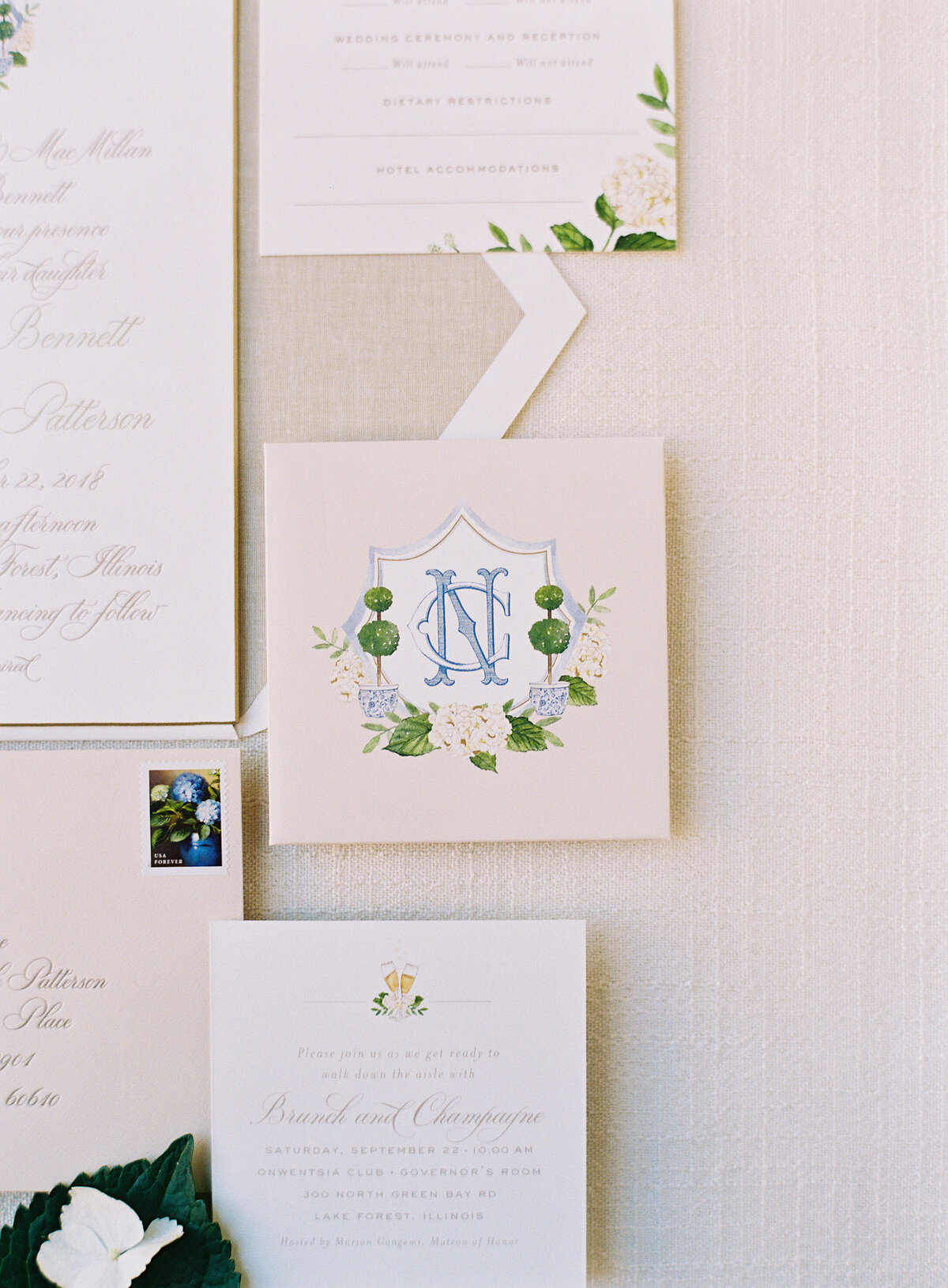 Close up of the wedding invitations with initials of the bride and groom. 
