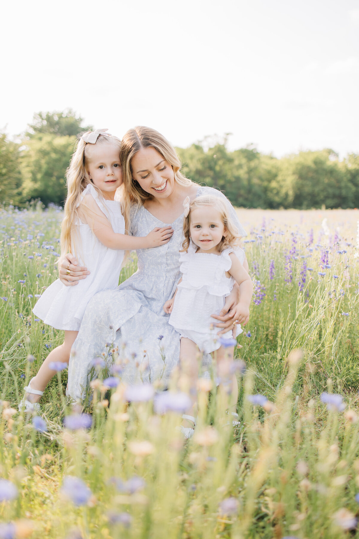 Motherhood wildflower session with a mother and her two daughters located in Richardson, TX.
