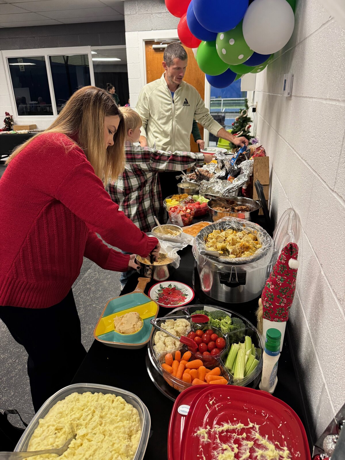 Guests enjoying a delicious catering buffet setup during a private event at 3rd Shot Pickleball. Perfect for gatherings and celebrations, the buffet offers a variety of mouthwatering options.