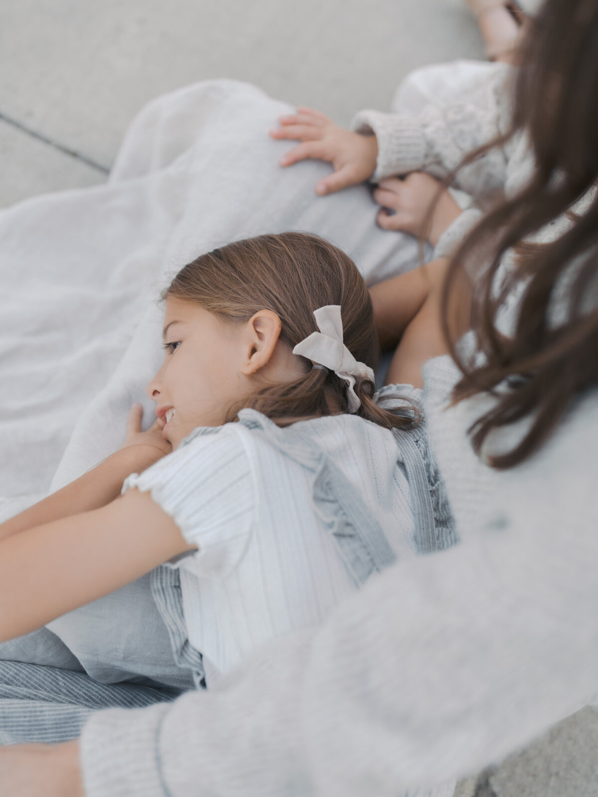Girl laying in mom's lap photo by Colorado Springs Family Photographer | Lauren Bounds